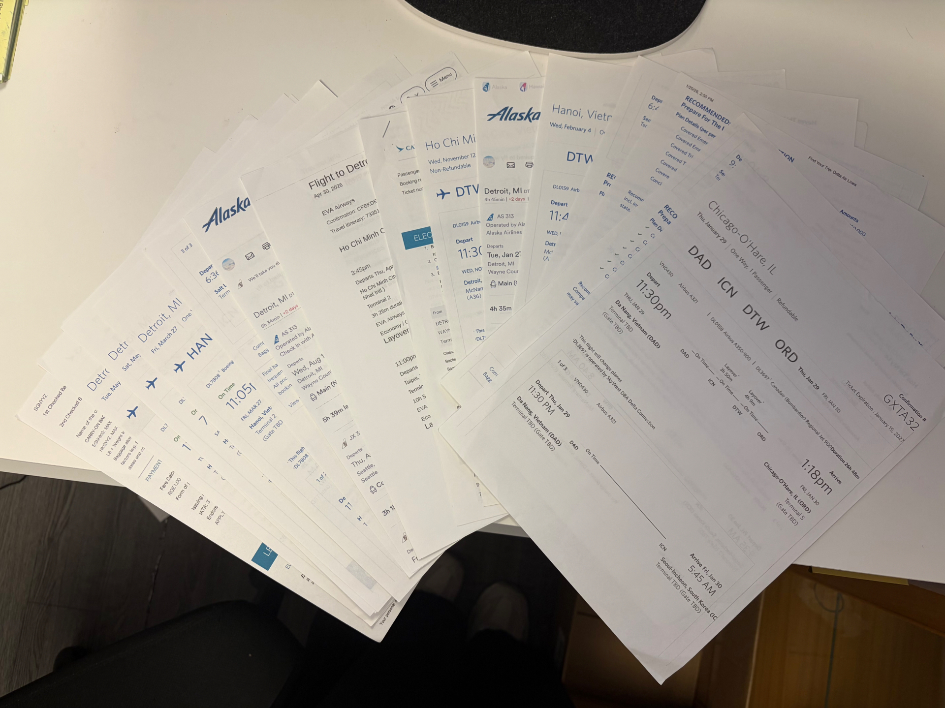 Stack of printed airline confirmations and itineraries